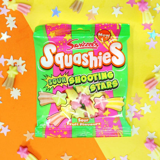 A bright and colourful bag of Swizzels Squashies Sour Shooting Stars sweets, featuring star-shaped candies in pastel colours on an orange and yellow background. The packaging highlights that the sweets are sour fruit flavoured and newly released.