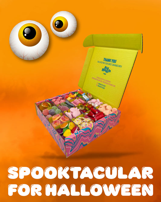 Big Mouth Candy Halloween sweet box filled with colourful pick-and-mix treats in a pink and purple patterned box on an orange background with cartoon eyeballs