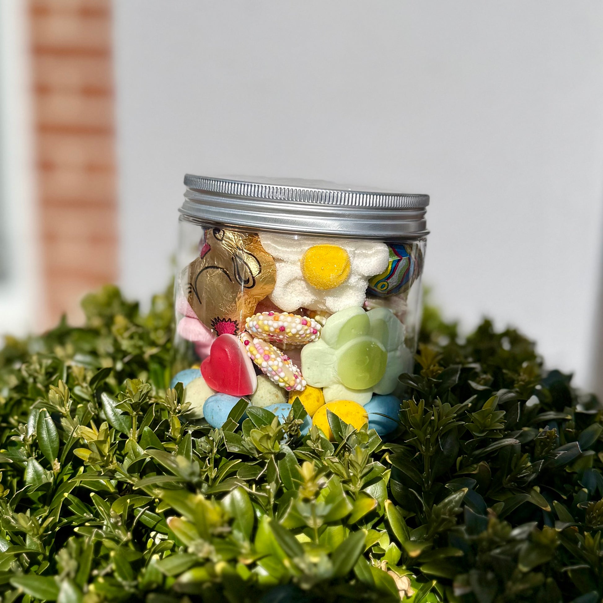 Spring pick and mix sweet jar from Big Mouth Candy, filled with chocolate bunny, jelly sweets, candy eggs, and marshmallows – displayed outdoors in natural light, perfect Easter treat or gift jar