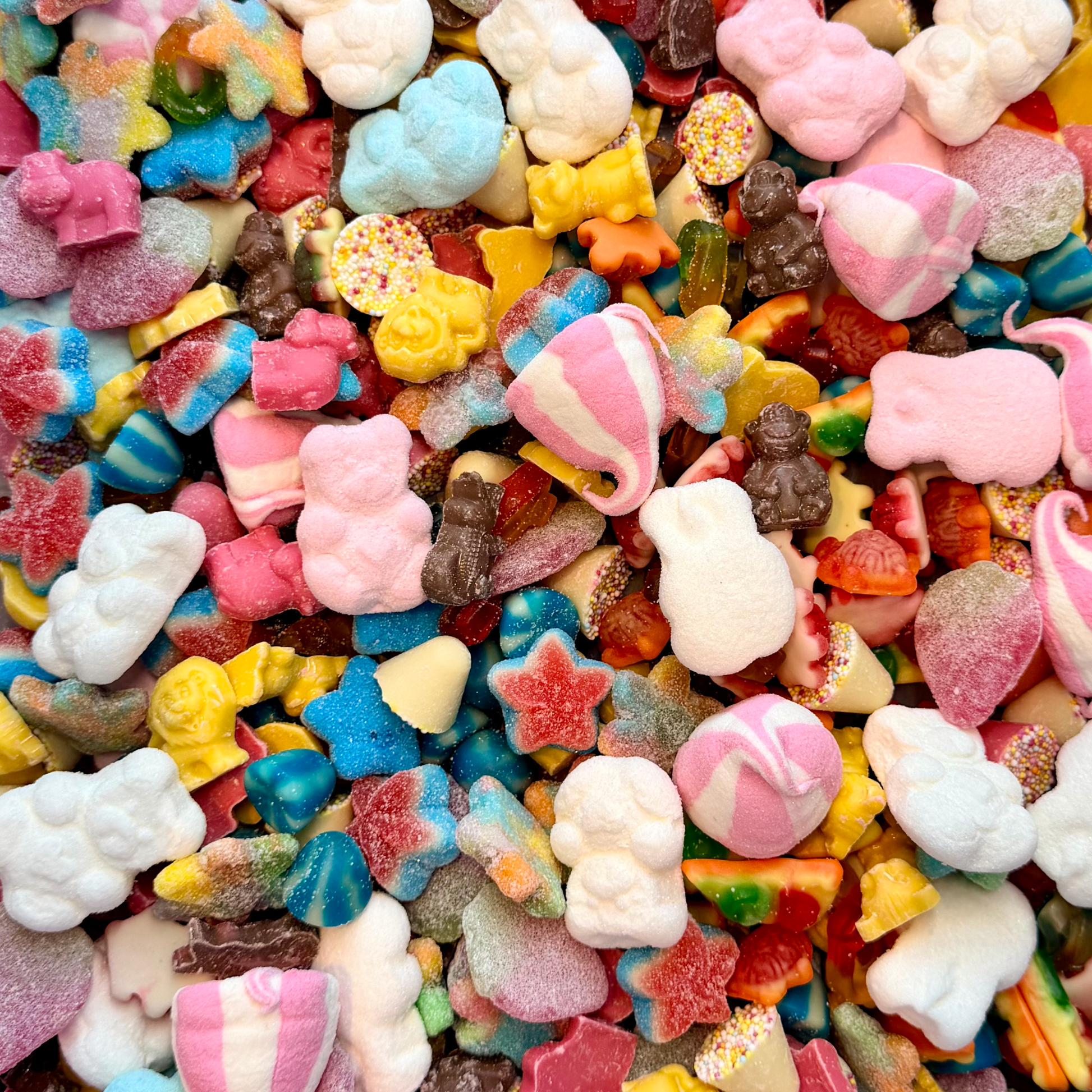 Assorted colorful gummy candies including bears, stars, and hearts.
