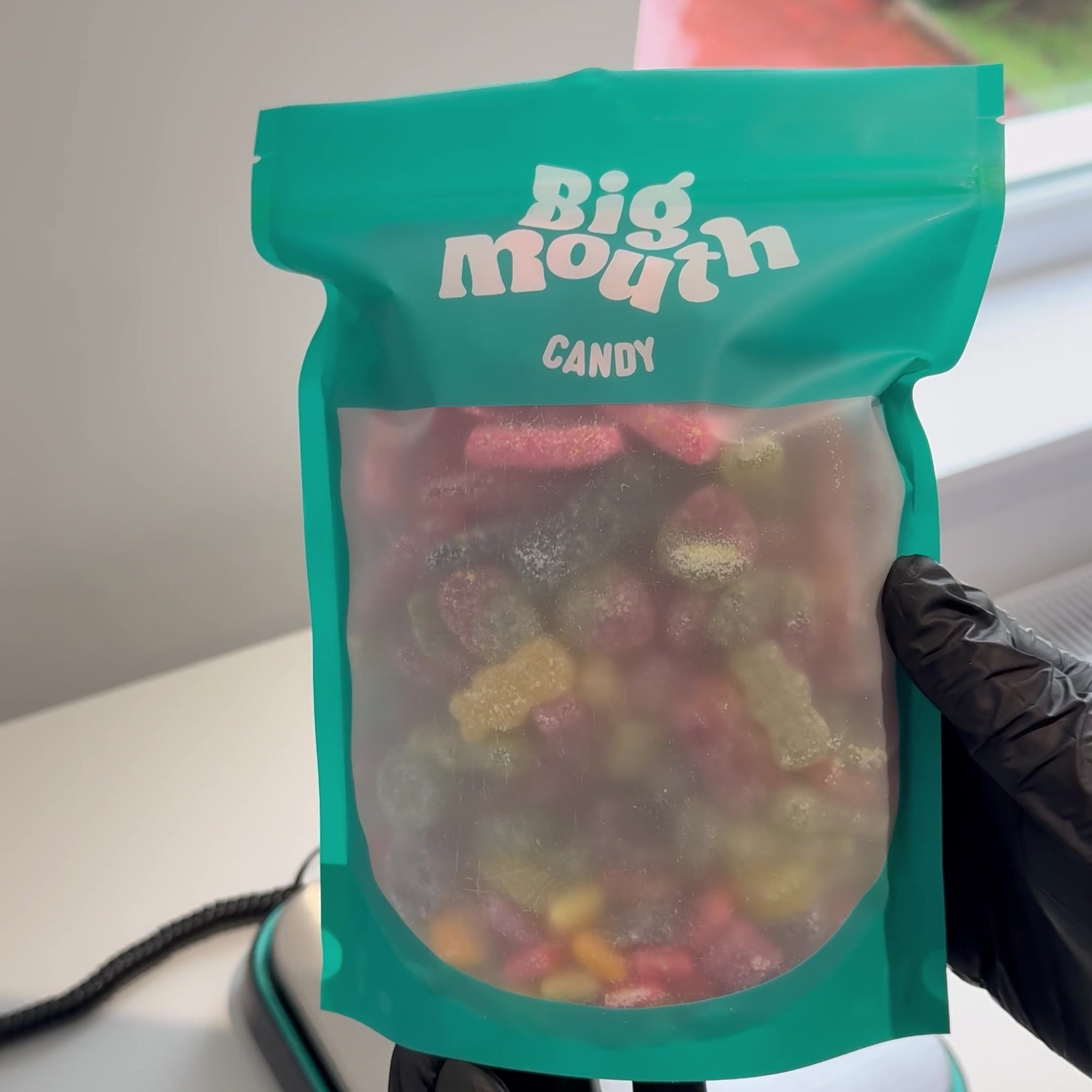 Video shows packing of a Big Mouth Candy brand edition pick and mix sweet bag. The resealable blue pouch is filled with colourful branded sweets like Starburst, Rowntree’s, Maynards, Wham, and Sour Patch. Ideal for candy delivery, sweet bags, and pick and mix UK lovers